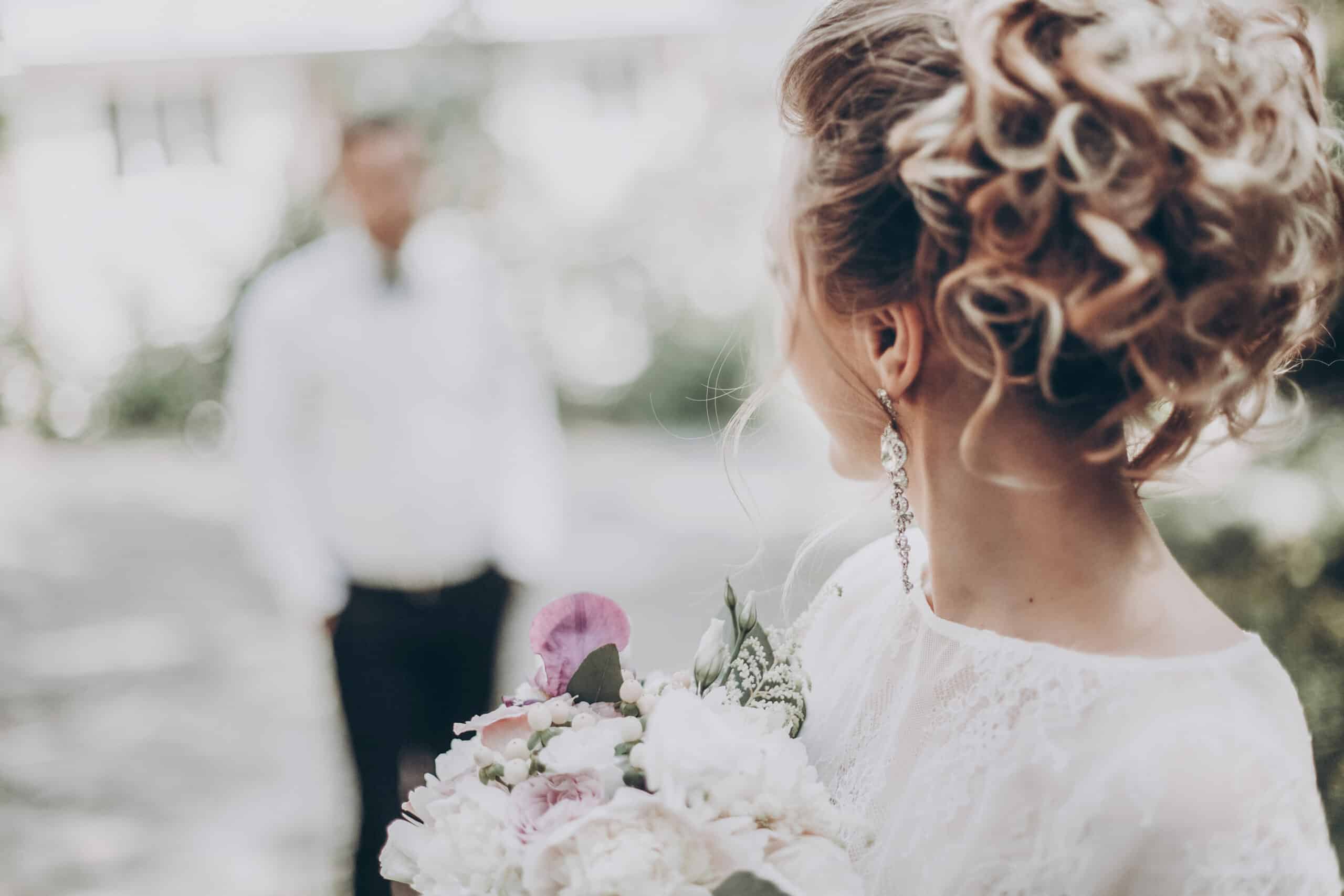 stylish wedding bride with bouquet and amazing modern dress